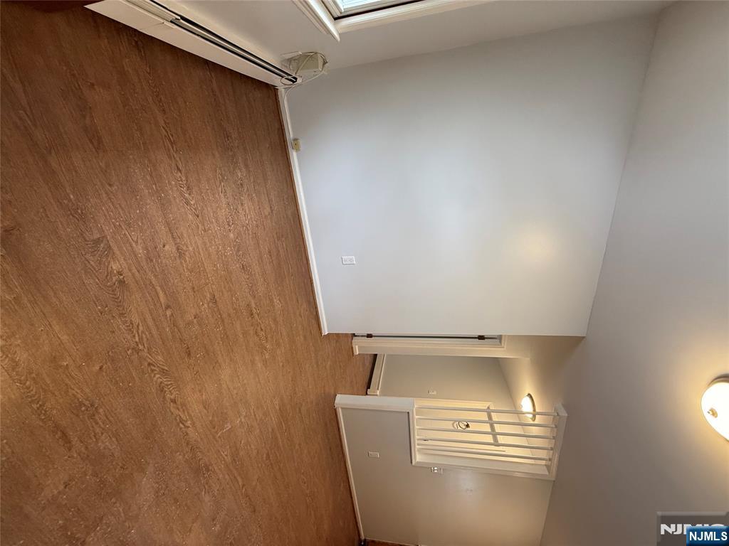50 Buschmann Avenue Haledon, NJ 07508 - Photo 8 of 8 an empty room with stairs and wooden floor