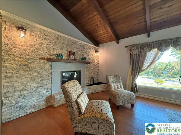 a kitchen with stainless steel appliances granite countertop a stove top oven a sink dishwasher and a refrigerator with wooden floor