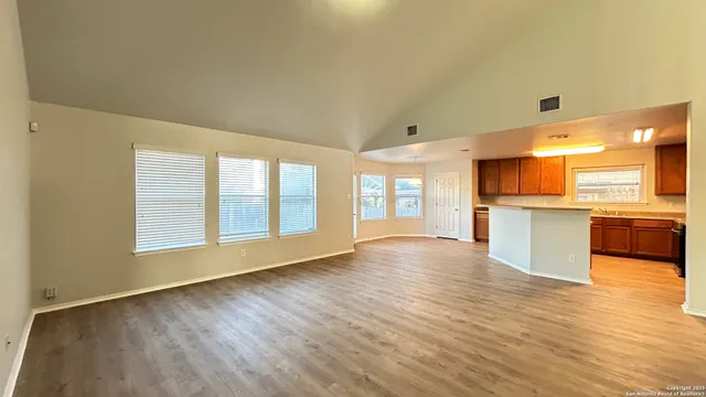 a view of a kitchen with a sink and a large window