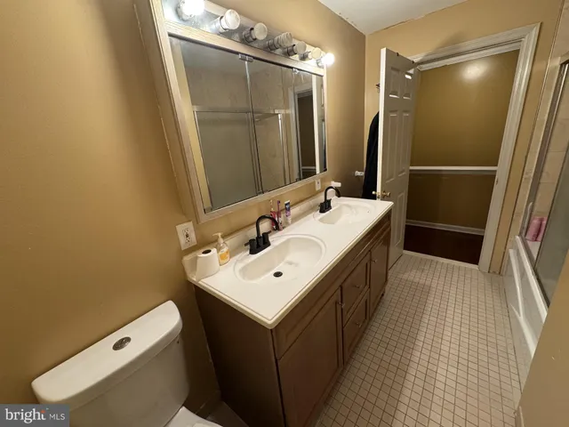 a bathroom with a sink a toilet and mirror