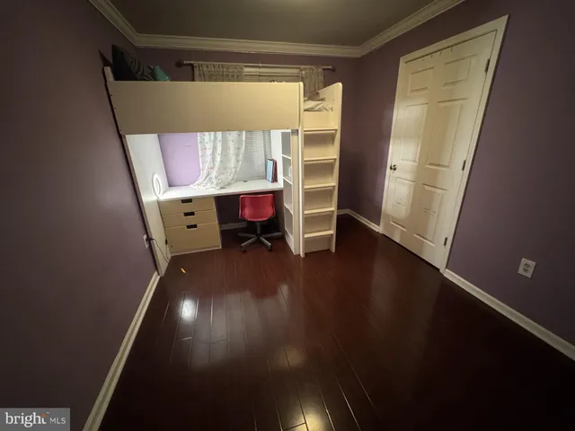 a room with wooden floor and a window