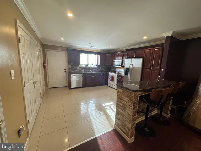 a kitchen with a sink appliances and cabinets