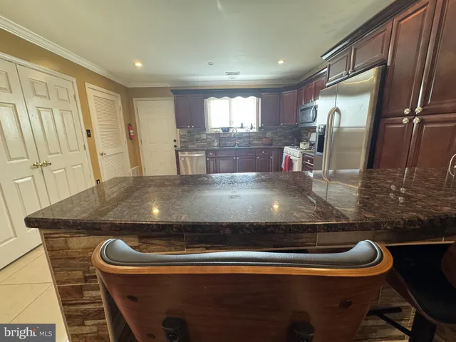 a kitchen with a stove and a refrigerator