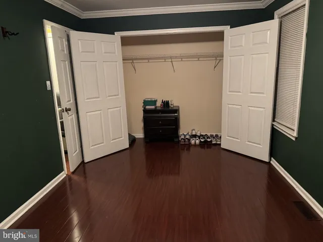 a view of a closet with wooden floor