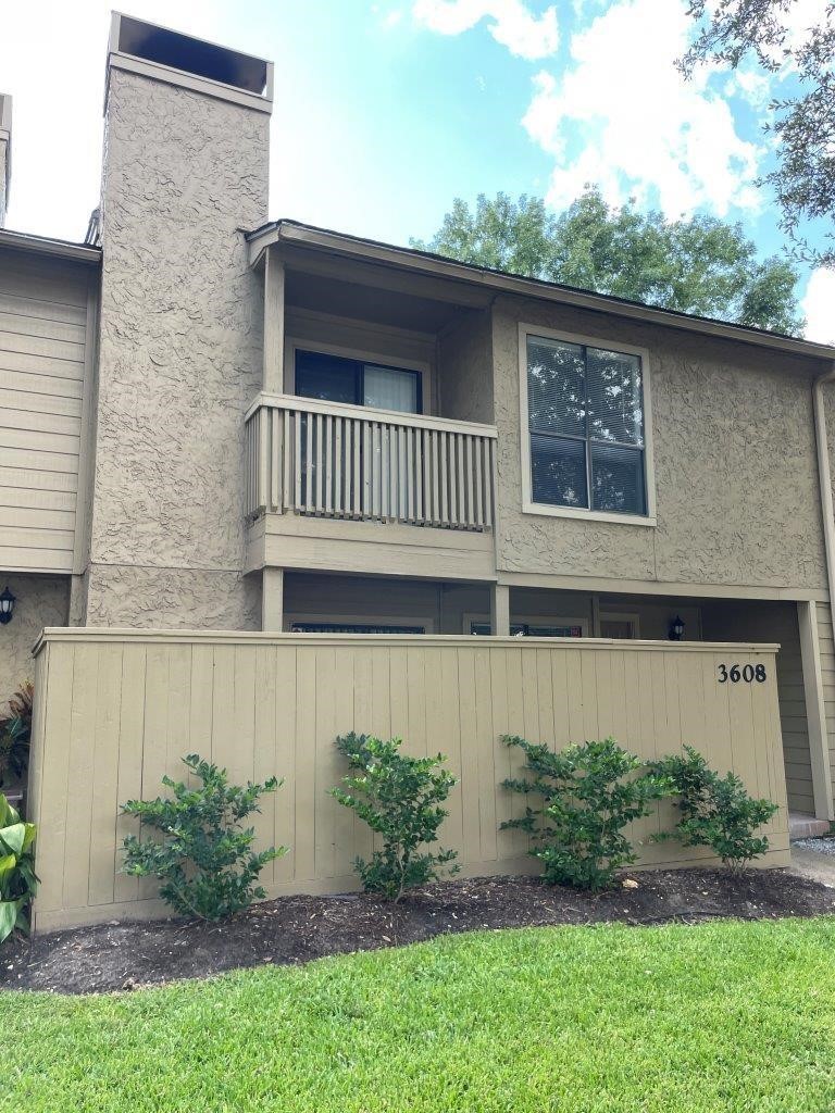 3608 Ocee Street Houston, TX 77063 - Photo 1 of 19 a view of a house with brick walls and a yard with plants