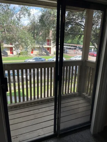 a room with a large tree and wooden fence