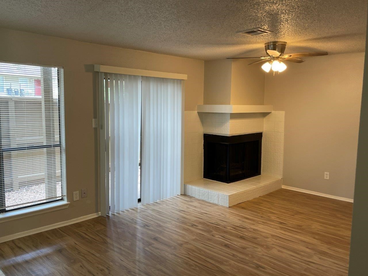 3608 Ocee Street Houston, TX 77063 - Photo 2 of 19 a view of a livingroom with a fireplace and wooden floor