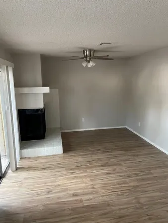a room with a wooden floor and shelf