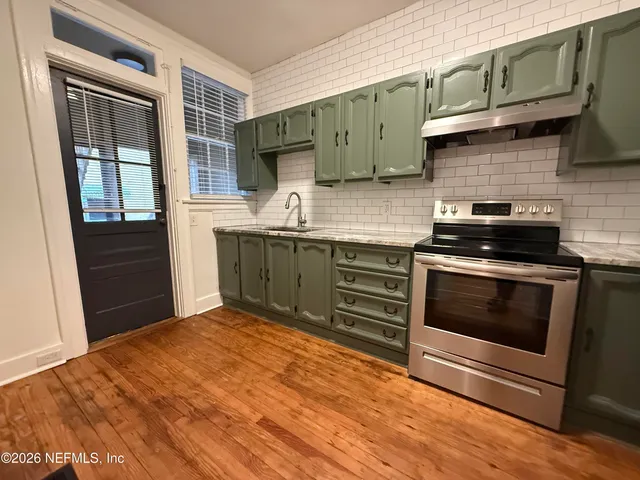 a kitchen with stainless steel appliances granite countertop a stove and a sink