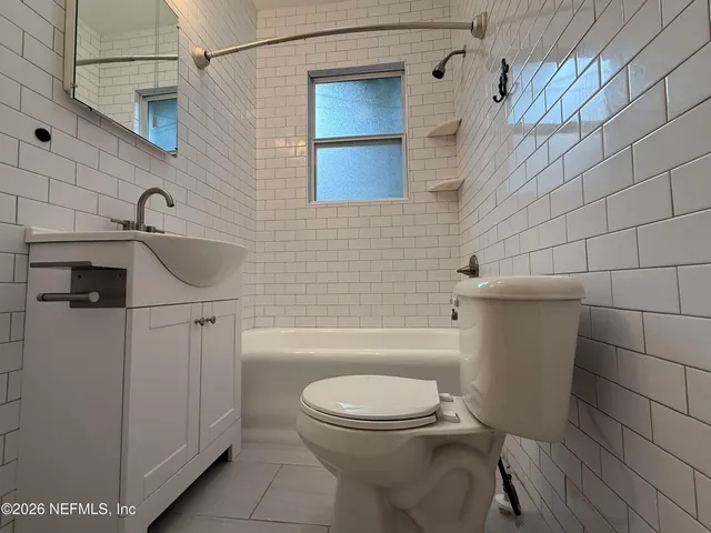 a bathroom with a toilet a sink and bathtub