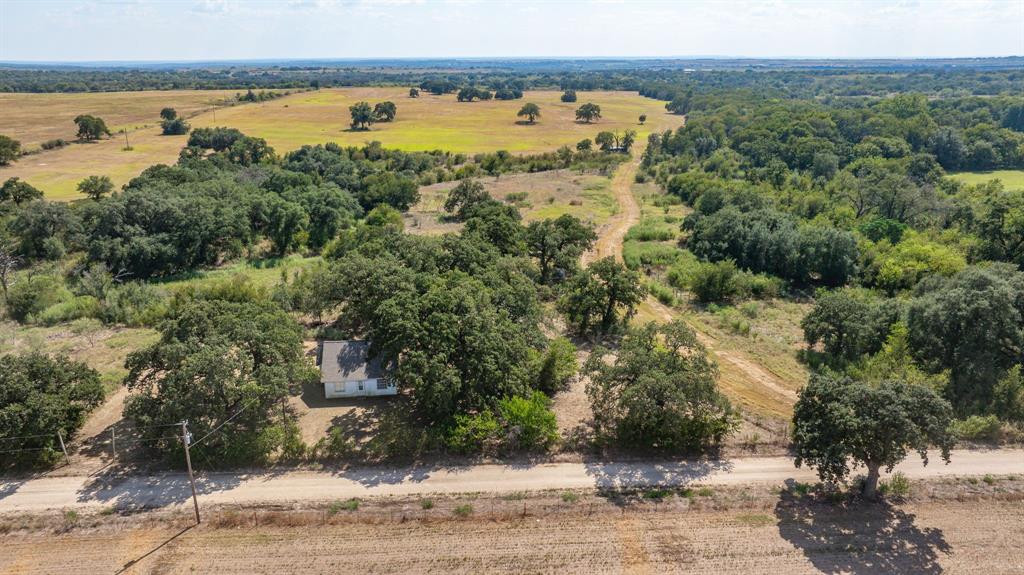 3066 County Road 285 Dublin, TX 76446 - Photo 37 of 40 a view of a lake with beach and wooden fence
