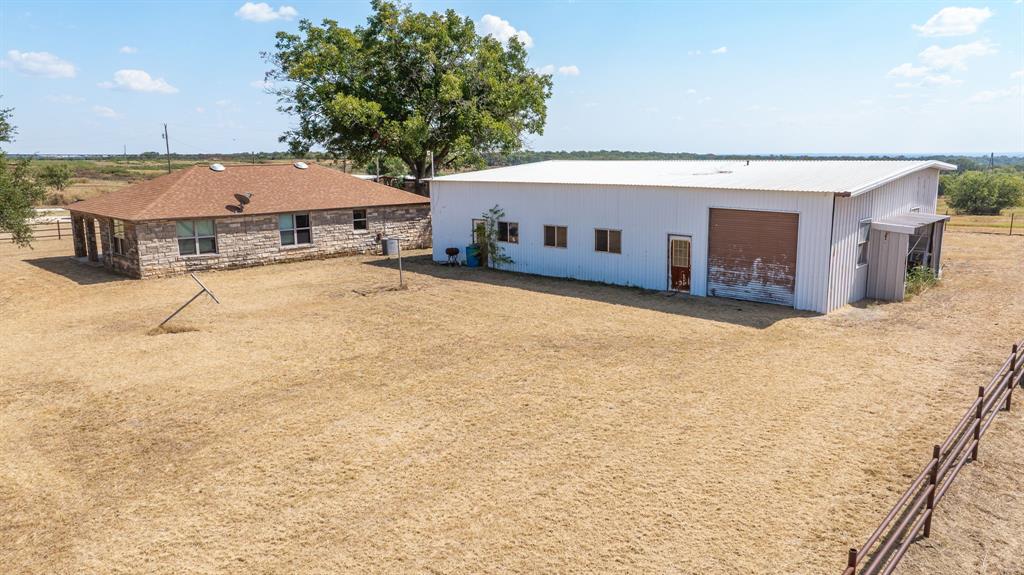 3066 County Road 285 Dublin, TX 76446 - Photo 5 of 40 a view of a house with a backyard and a tub