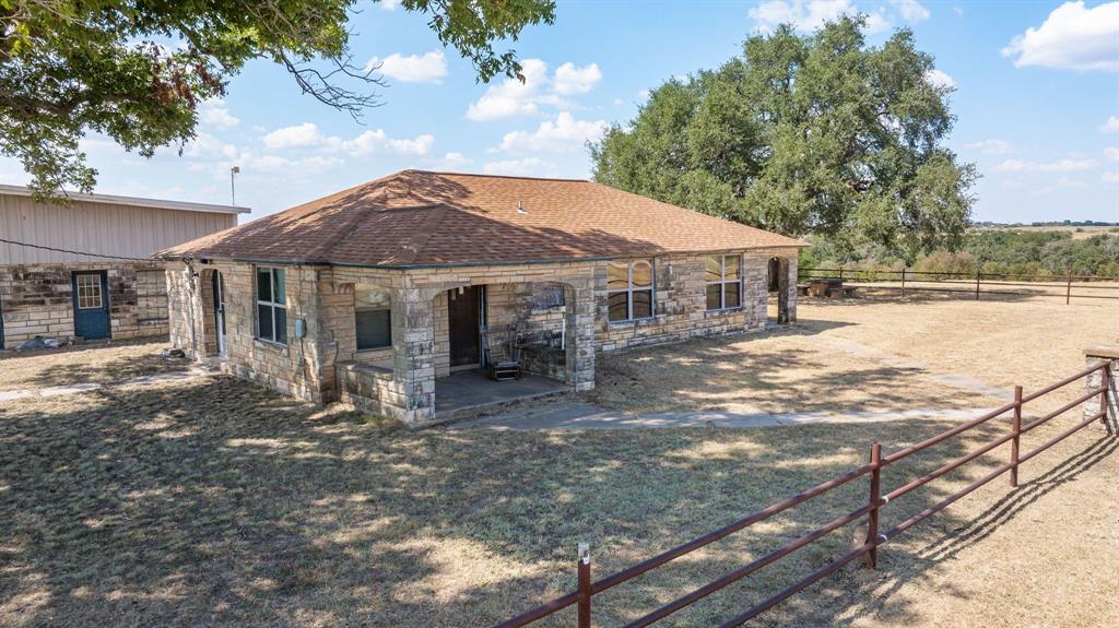 3066 County Road 285 Dublin, TX 76446 - Photo 8 of 40 a patio with a table and chairs under an umbrella