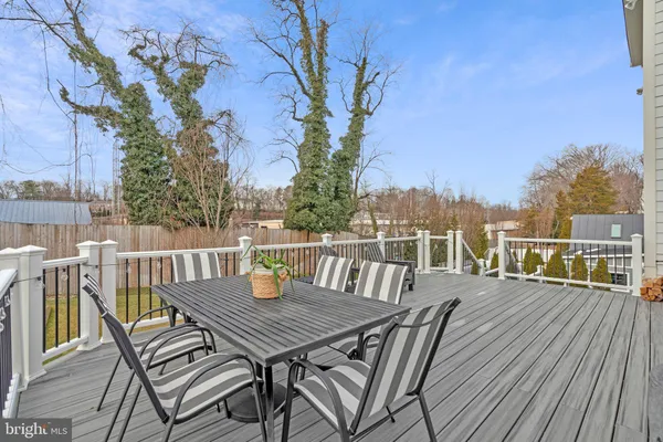 a view of a deck with furniture and wooden floor