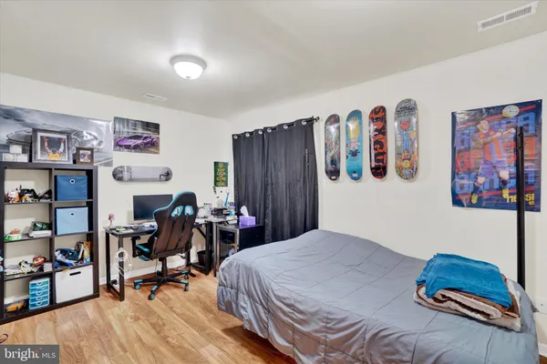 a bedroom with a bed and a desk