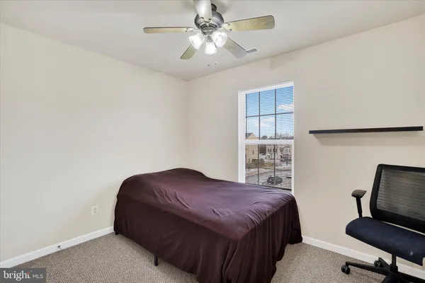 a bedroom with a bed and a desk