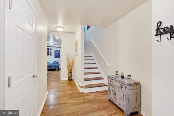 a view of a hallway with entryway wooden floor and front door