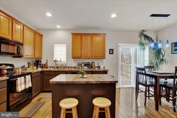 a kitchen with a table chairs sink and cabinets