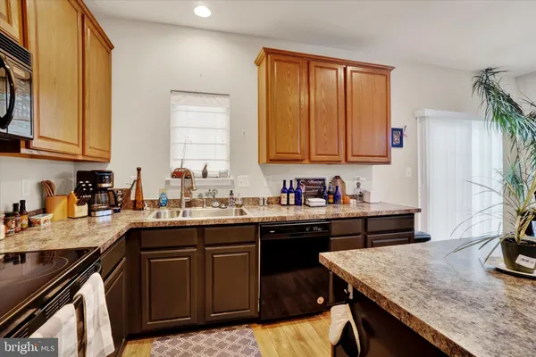 a kitchen with a sink a stove and cabinets