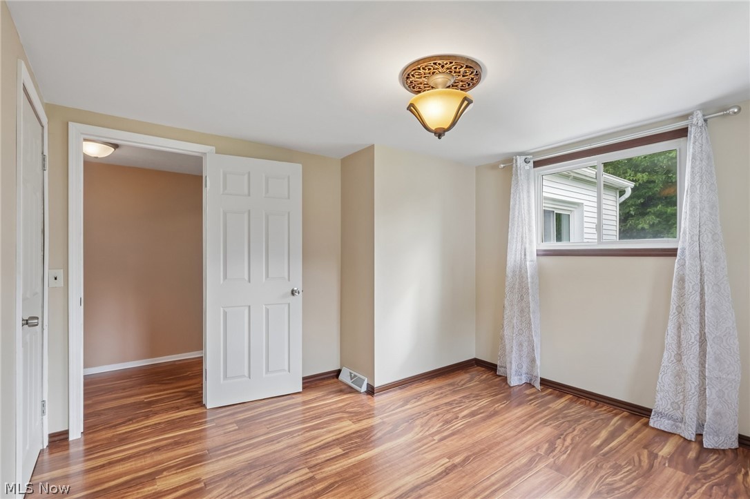 4188 Manchester Road Perry, OH 44081 - Photo 23 of 41 Wood-finish flooring throughout, bright window, and an overhead decorative light fixture