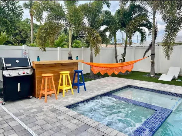 an outdoor space with pool and furniture