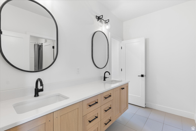 1192 East Corral Way Washington, UT 84780 - Photo 53 of 81 Dual oval mirrors above a light wood-finish vanity with ample storage