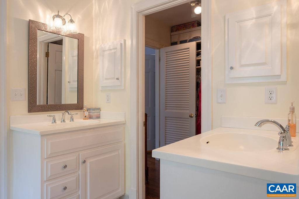 969 Tanglewood Road Charlottesville, VA 22901 - Photo 38 of 62 a bathroom with a sink and a mirror