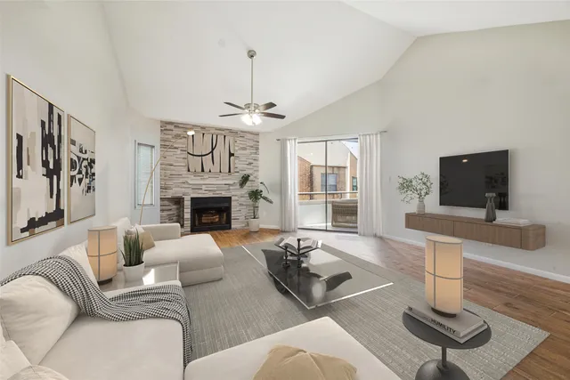 a living room with furniture a fireplace and a flat screen tv