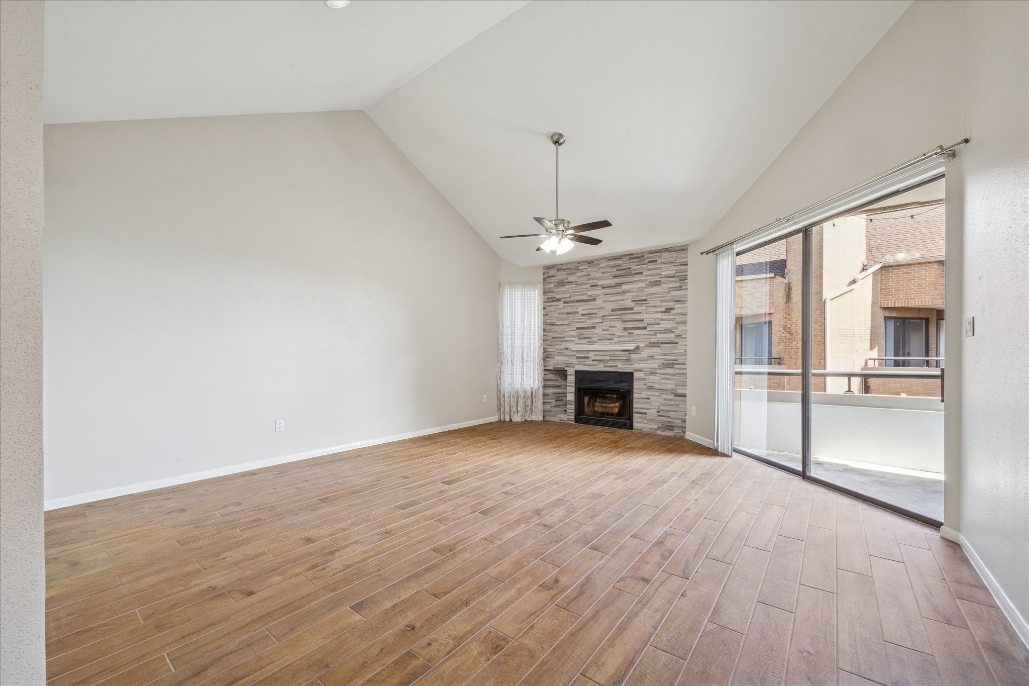5210 Weslayan Street, Unit 303 Houston, TX 77005 - Photo 3 of 16 a view of an empty room with a fireplace and a window