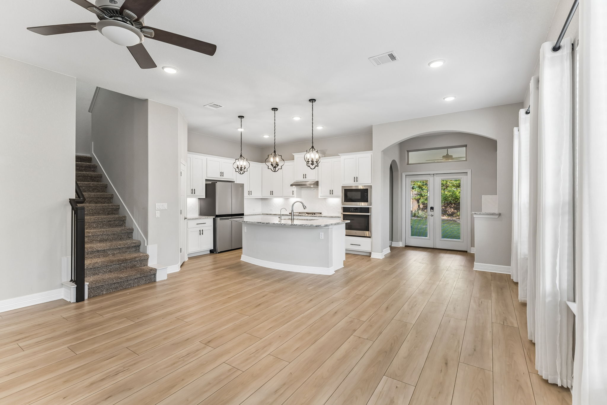 2009 Running Brushy Bend Leander, TX 78641 - Photo 11 of 32 a view of a kitchen with furniture and wooden floor
