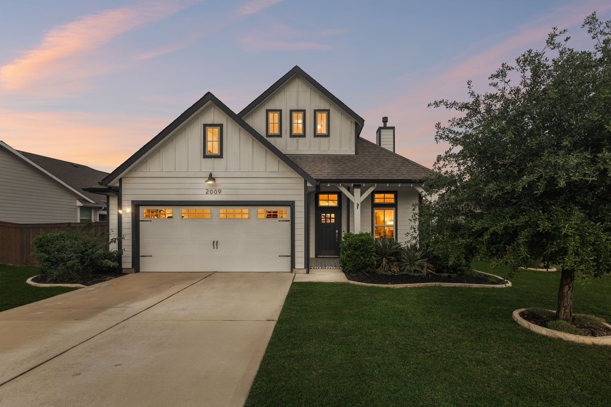 2009 Running Brushy Bend Leander, TX 78641 - Photo 31 of 32 a front view of a house with a yard and garage