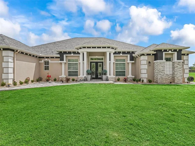 a living room with furniture a dining table and a large window
