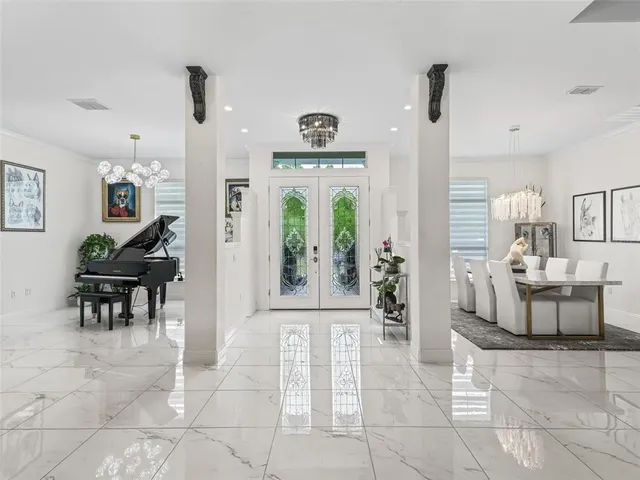 a dining table with chairs and chandelier