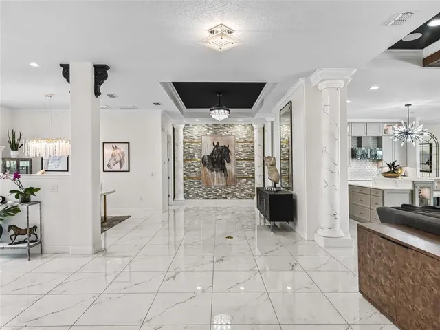 a living room with furniture and a chandelier