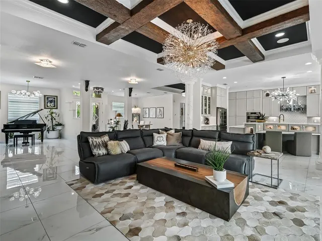 a living room with furniture and large windows