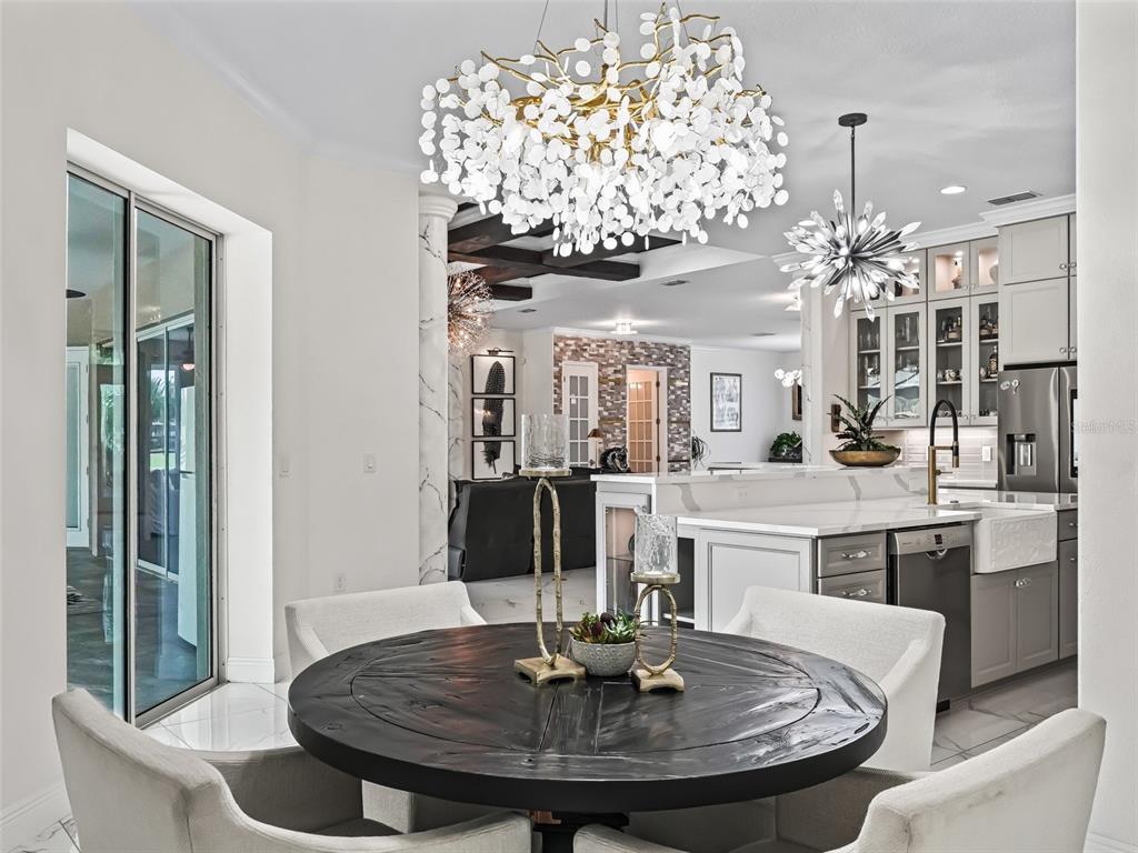 7161 Northeast 22nd Ct Road Ocala, FL 34479 - Photo 47 of 81 a dining table with chairs and chandelier