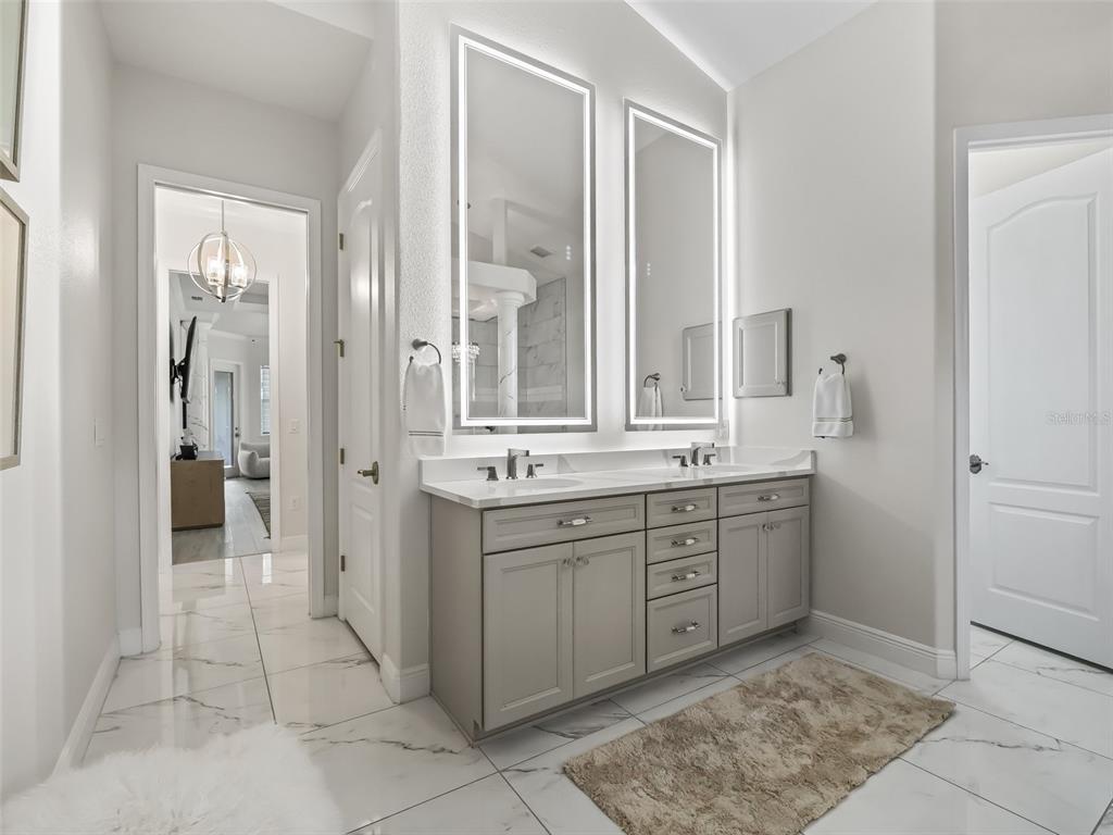 7161 Northeast 22nd Ct Road Ocala, FL 34479 - Photo 55 of 81 a spacious bathroom with a mirror and a sink