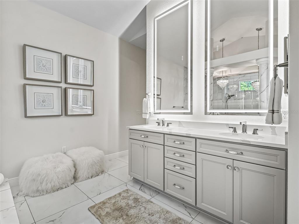 7161 Northeast 22nd Ct Road Ocala, FL 34479 - Photo 56 of 81 a bathroom with a double vanity sink and a mirror