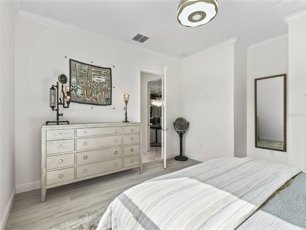 7161 Northeast 22nd Ct Road Ocala, FL 34479 - Photo 62 of 81 a bedroom with a bed and a dresser