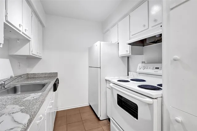 a kitchen with a stove sink and refrigerator