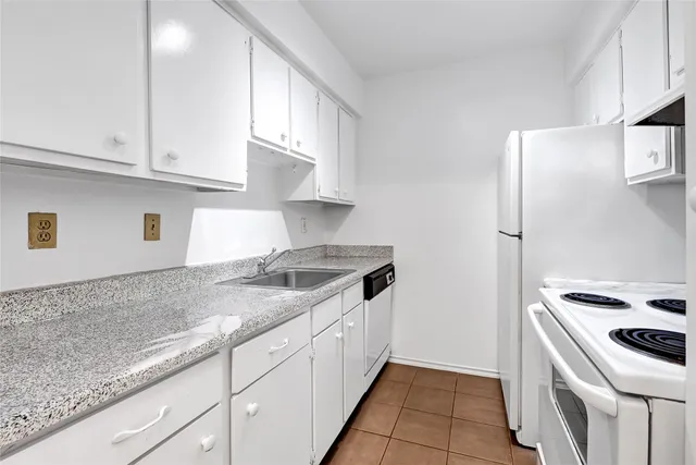 a kitchen with granite countertop cabinets and steel stainless steel appliances