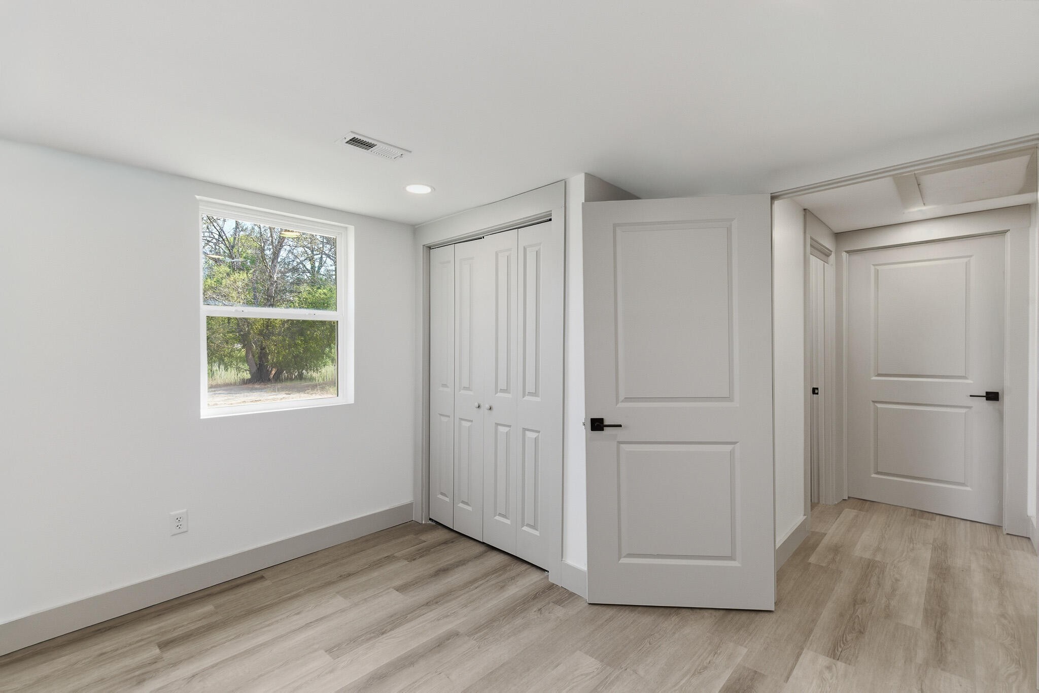 2317 Howell Street Cleveland, TN 37323 - Photo 15 of 39 a view of an empty room with a window and wooden floor