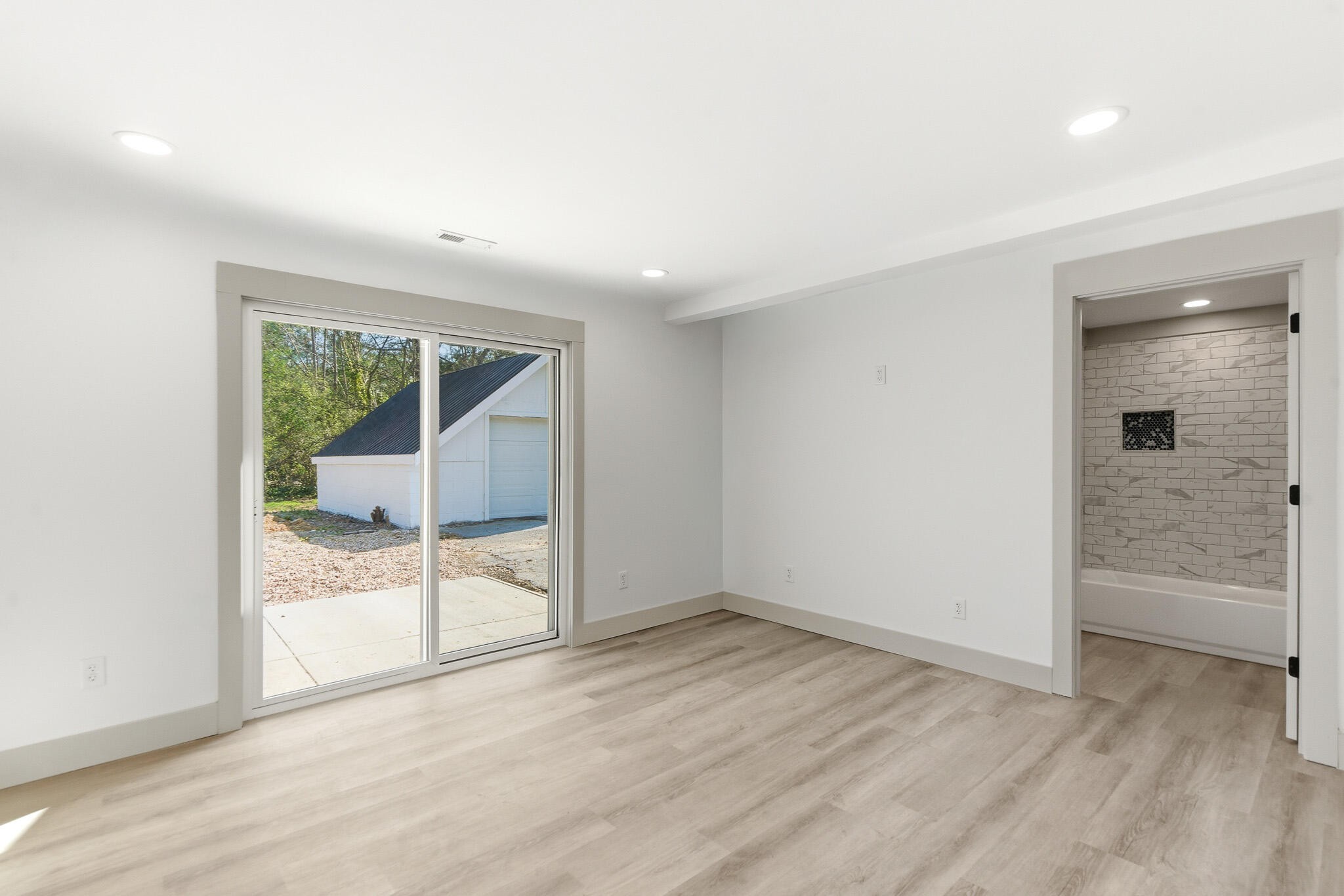 2317 Howell Street Cleveland, TN 37323 - Photo 25 of 39 an empty room with wooden floor and windows