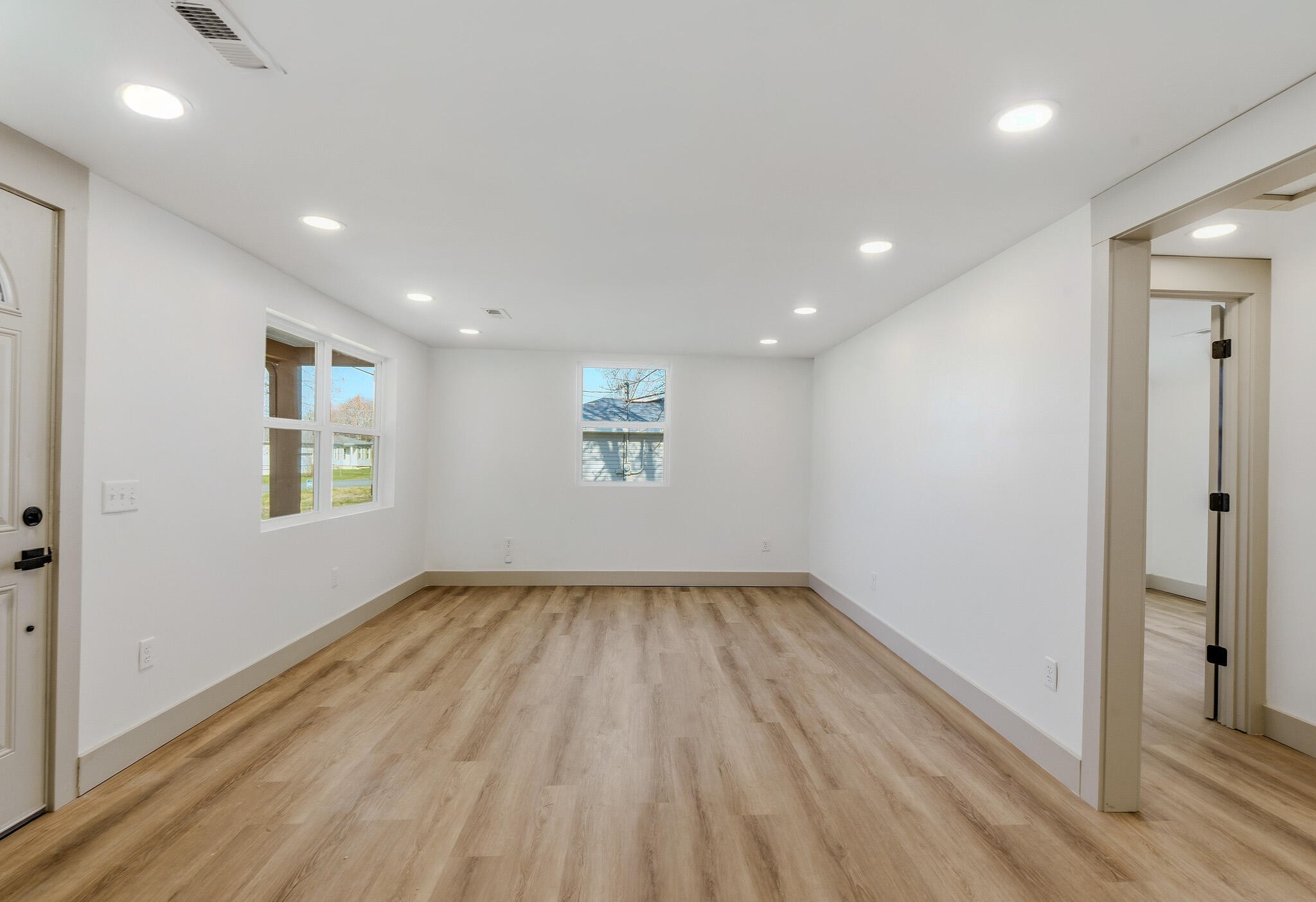 2317 Howell Street Cleveland, TN 37323 - Photo 8 of 39 an empty room with wooden floor and windows