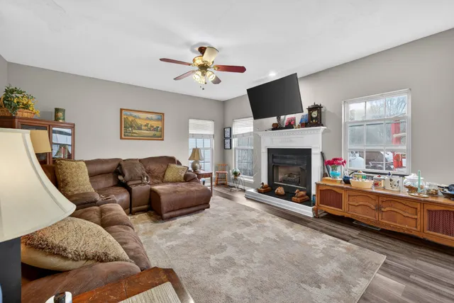 a living room with furniture and a fireplace