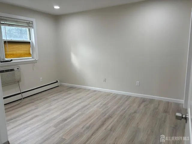 a view of an empty room and wooden floor