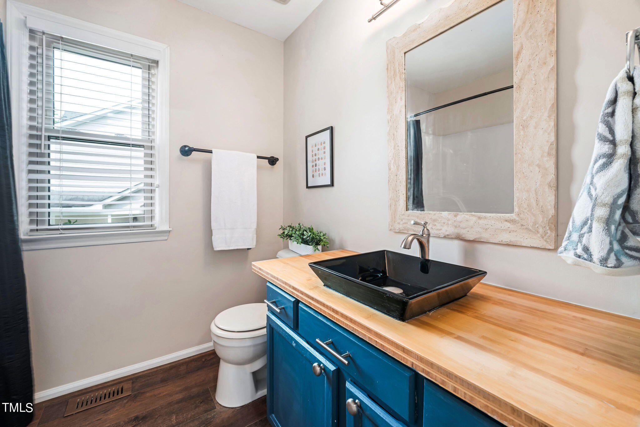 4400 Emmit Drive Raleigh, NC 27604 - Photo 11 of 38 a bathroom with a sink a toilet and a window