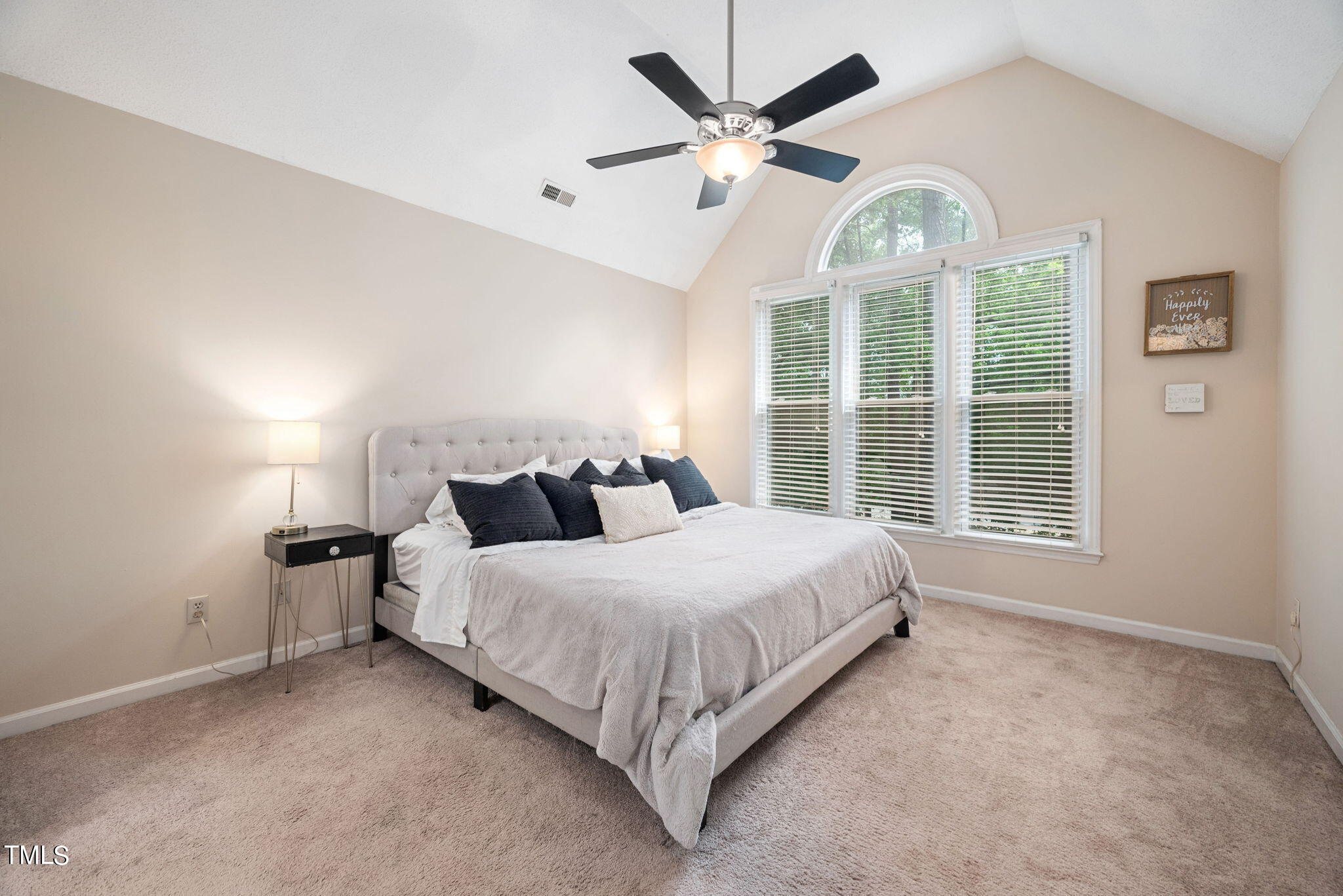 4400 Emmit Drive Raleigh, NC 27604 - Photo 15 of 38 a spacious bedroom with a large bed and a chandelier fan