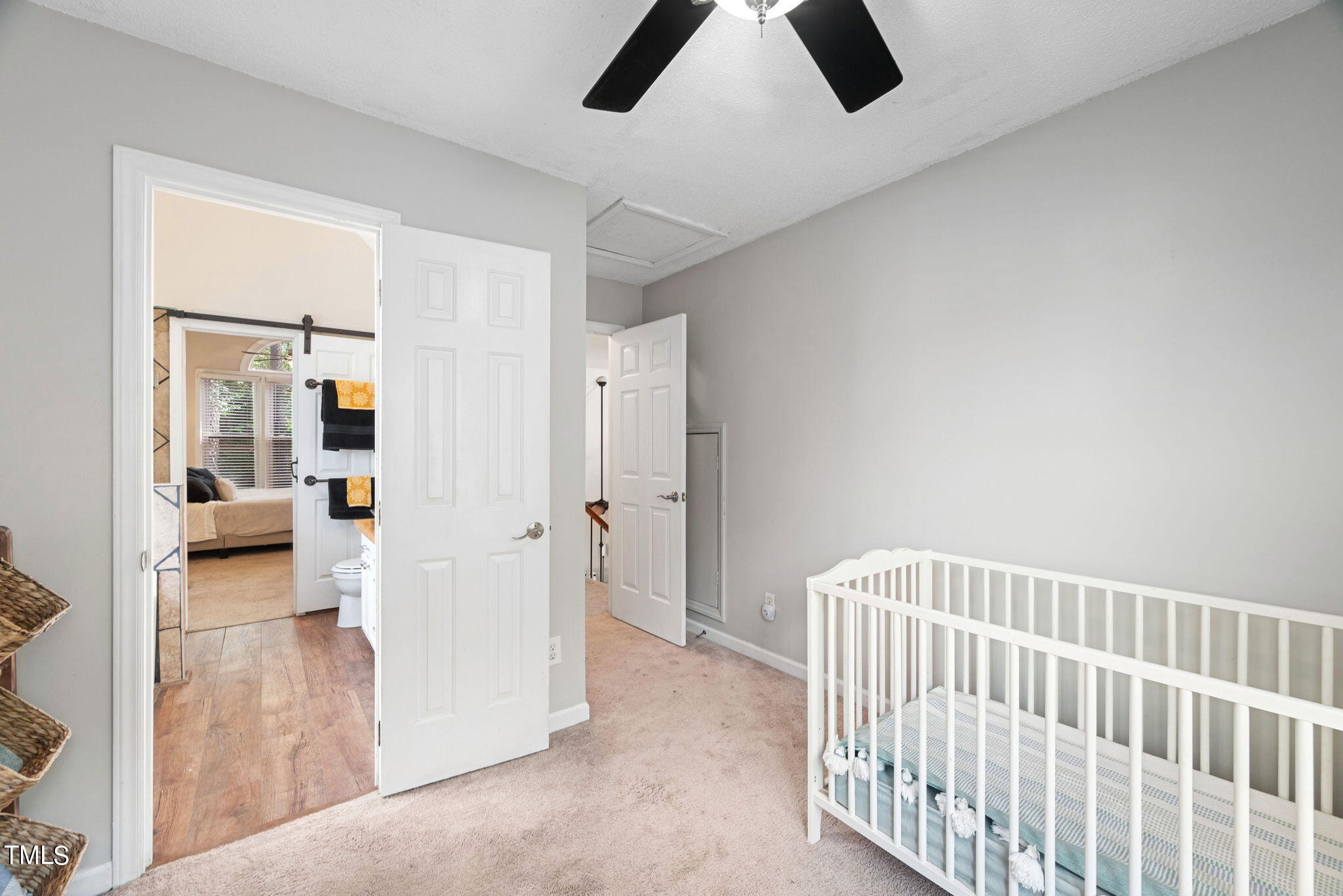 4400 Emmit Drive Raleigh, NC 27604 - Photo 22 of 38 a view of a hallway to a livingroom with wooden floor and windows