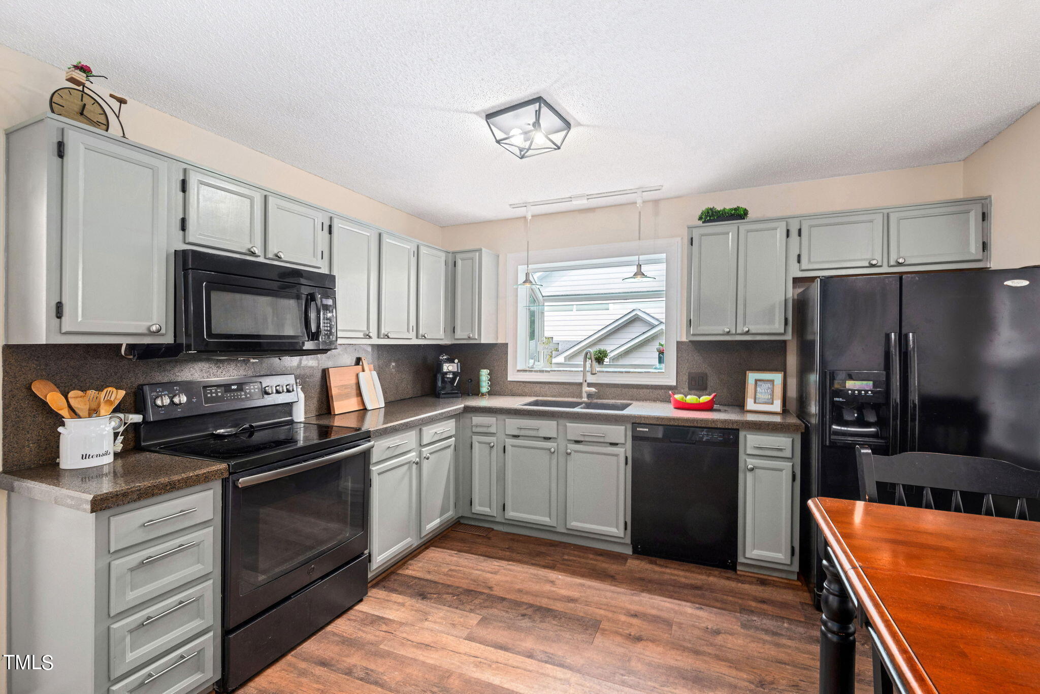 4400 Emmit Drive Raleigh, NC 27604 - Photo 7 of 38 a kitchen with stainless steel appliances granite countertop a refrigerator stove microwave and sink